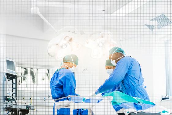 Surgical team performing an operation in a hospital room that requires strict indoor air quality and ventilation control.